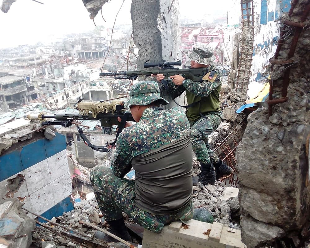 Marine Corps soldiers in the middle of a battle