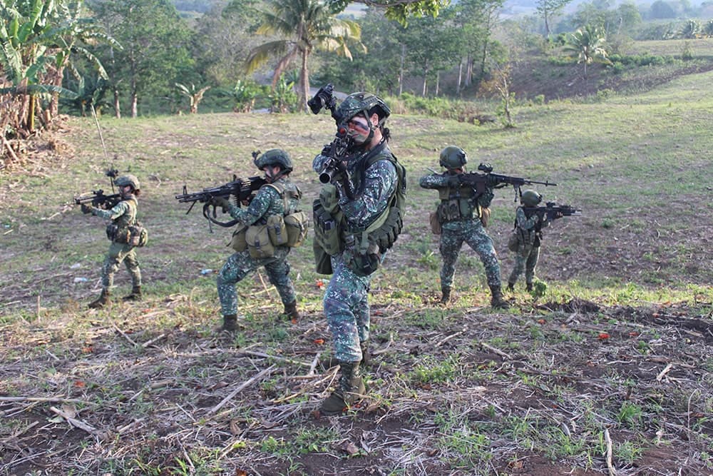 Female Marines in full combat gear