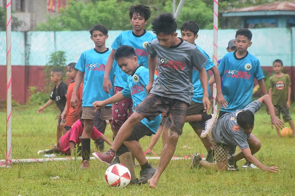 Kids throwing yellow balls during the Football for Peace Festival