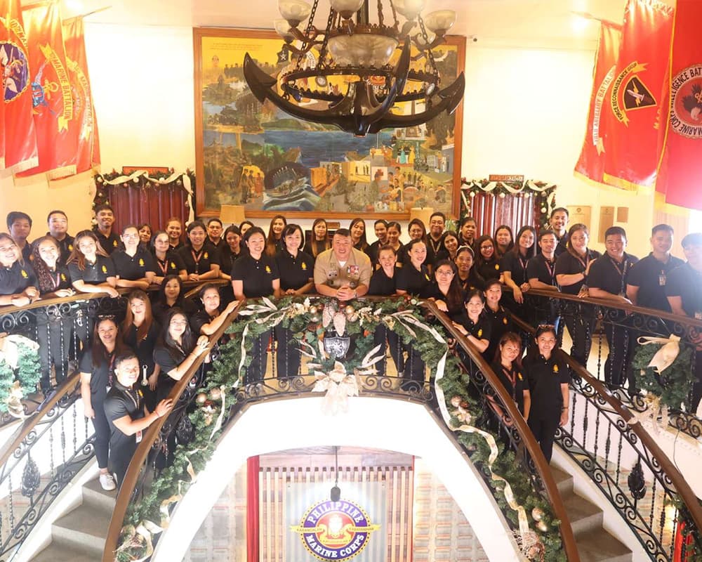 Civilian of Marine Corps standing in triangle formation